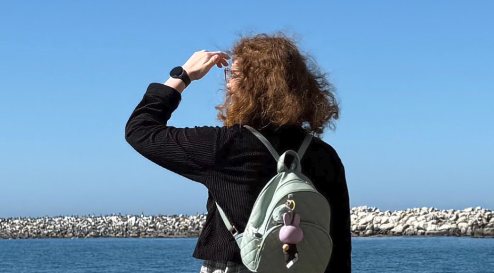 Picture of Jasmine looking out at water on a beach